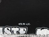 a black and white picture of graffiti on the side of a building