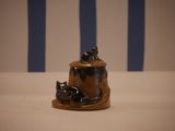 a small figurine of a cat and a dog on a table