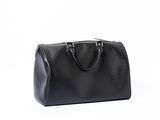 a black leather handbag on a white background