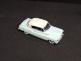 a toy car that is sitting on a black surface