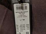 the back of a brown jacket with a black label on it