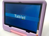 purple and pink tablet computer sitting on top of a white table