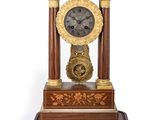 a clock that is sitting on top of a wooden stand