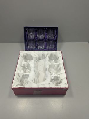 a box of wine glasses sitting on a table