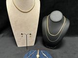 three pieces of jewelry are displayed on a black background