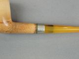 a pipe that is sitting on a table next to a piece of wood