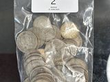 a bag of coins sitting on a table next to a cup of coffee