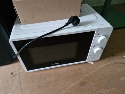 a microwave that has a box on top of it