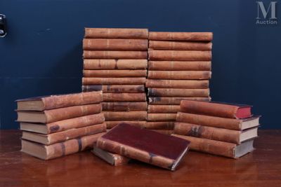 several old books stacked on top of each other on a table