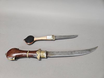 two knives sitting next to each other on a table