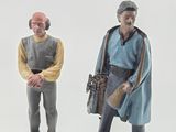 two figurines of a man and a woman standing next to each other