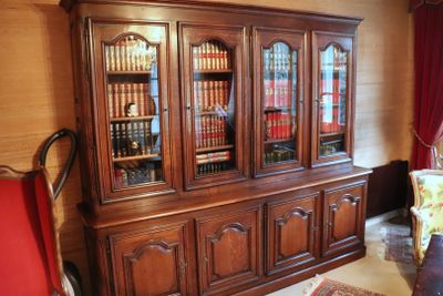 a large wooden bookcase with many books on it
