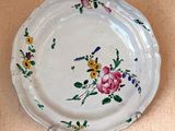 a white plate with flowers on it on a table