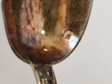 a close up of a silver spoon with a handle