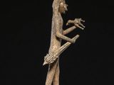 a bronze statue of a man playing a musical instrument