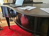 a laptop sitting on top of a piano in a living room