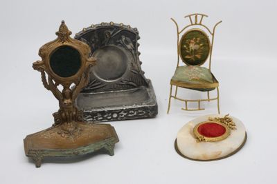 three miniature chairs and a mirror on a white surface