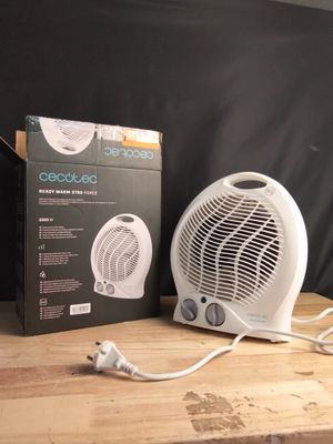 a white fan sitting on top of a wooden table next to a box