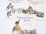 three books on a white table with a drawing of a man in a uniform