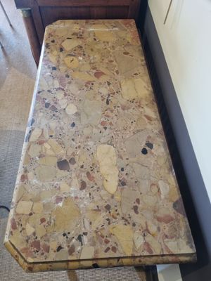 a small table with a marble top in a room