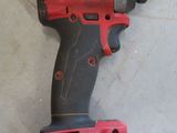 an image of a cordless drill that is on the floor