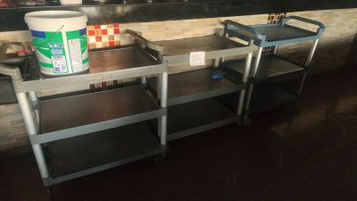 a metal cart with a bucket of food on top of it