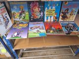 many children ' s books on a shelf in a store