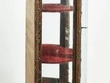 a glass display case with a red chair in it