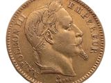 a close up of a gold coin with a woman ' s face