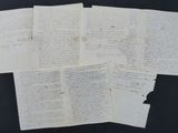 several pieces of old paper with writing on them on a black surface