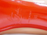 a close up of a pair of red shoes on a table