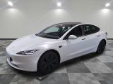 a white tesla model s is parked on a checkered floor