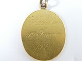 a close up of a gold medal on a white surface