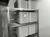 a metal shelf that has several bins on top of it