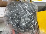 a box full of screws and other tools on a table