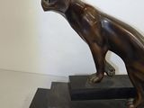 statue of a cat on a black base