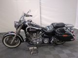 a black motorcycle that is parked on a checkered floor