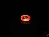 an orange diamond in the dark with a black background