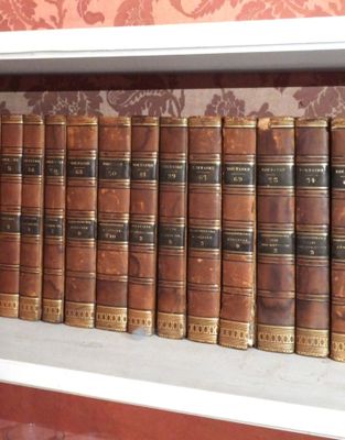 many old books on a shelf in a room