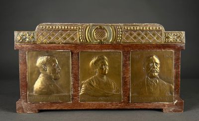 an image of a gold - plated chest with three portraits of men