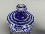 an image of a blue glass jar sitting on top of a table