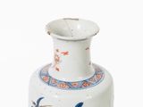 a white vase with a blue and red design on it