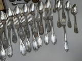a lot of silver spoons and spoon spoons on a table