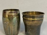 two vases sitting next to each other on a table