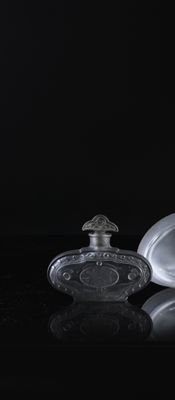 a bottle of perfume and a glass bottle on a table