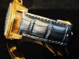 a close up of a watch on a black surface