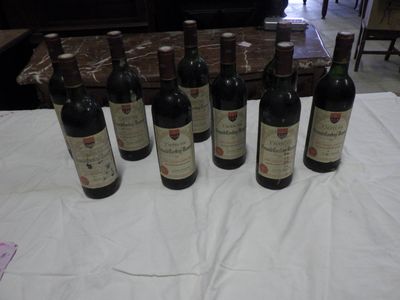 several bottles of wine are lined up on a table