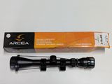 a close up of a rifle scope with a box on a table