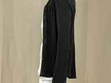 the mannequin is wearing a black jacket and white pants