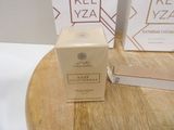 boxes on a wooden table with a box of perfume on top of it